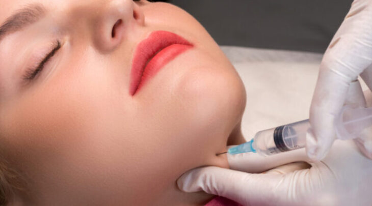 Chin lipofilling. Woman getting cosmetic injection of botulinum Chin lipofilling. Woman getting cosmetic injection of botulinum
